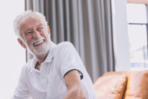 happy elderly man healthy senior confident smile with beautiful white teeth from denture prosthetics.