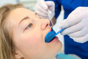 Dentist using a mouth guard on a a woman